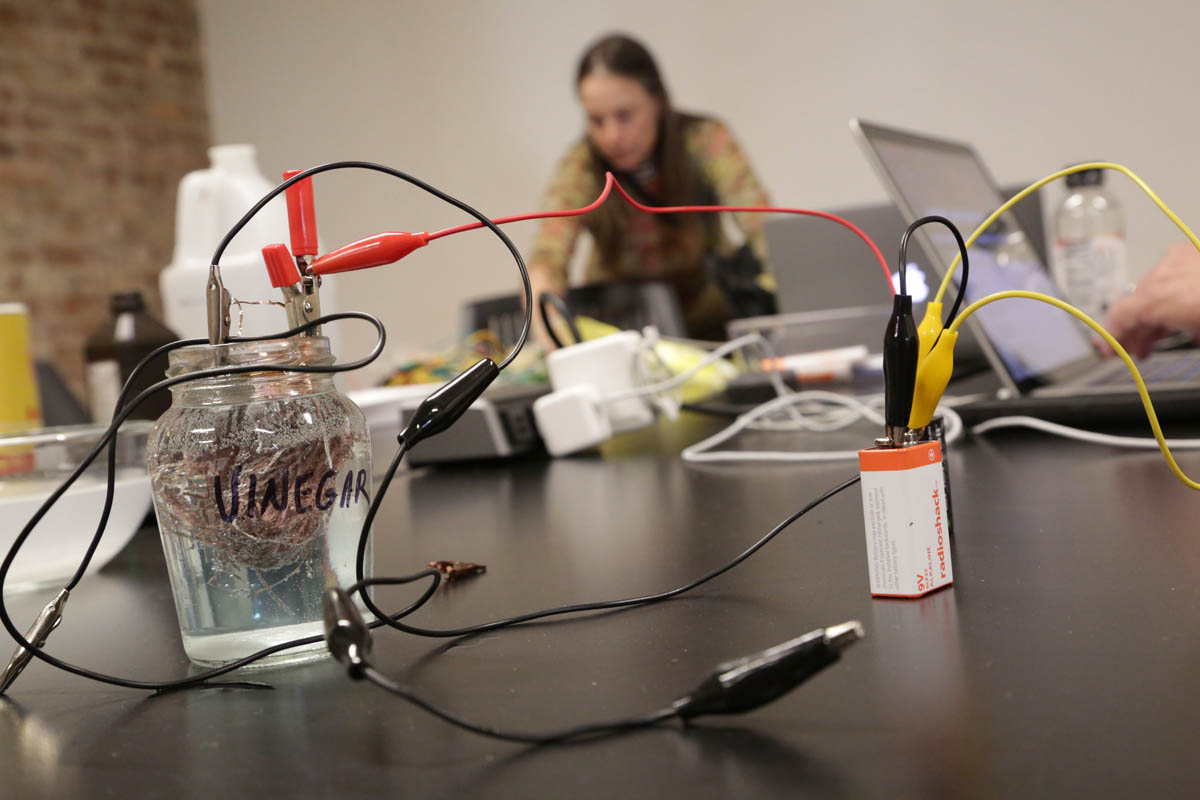 a battery, and wires hooked up to a copper ball immersed in liquid